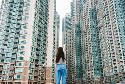 Woman standing in front of modern building