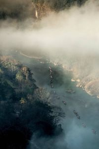 High angle view of people on mountain against sky