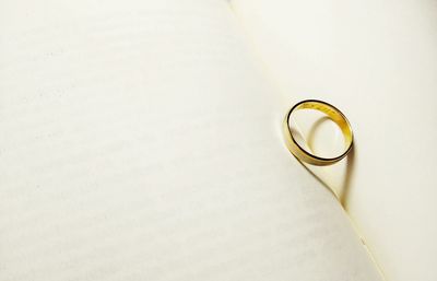 Close-up of wedding ring on open book