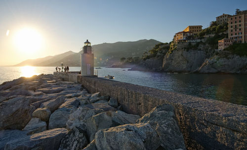 Scenic view of sea and buildings against clear sky