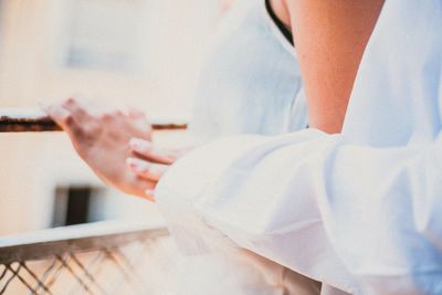 Midsection of couple standing at balcony