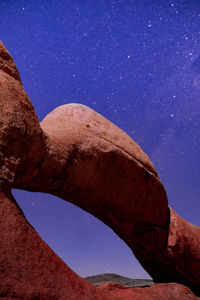 Low angle view of rock formation against blue sky