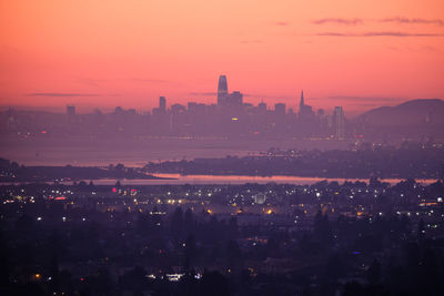 High angle view of illuminated buildings against sky during sunset