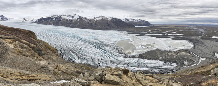 Scenic view of mountains and glacier against sky