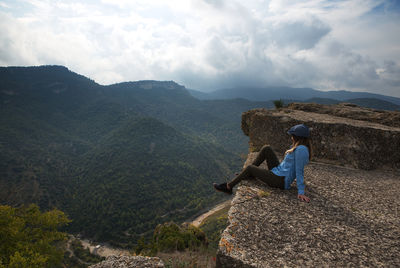 Woman enjoying the scenery from the top of the mountain.