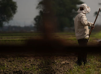 Side view of man standing on field