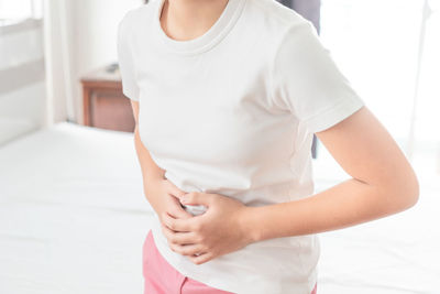 Midsection of woman standing at home
