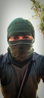 Portrait of a young man covering face