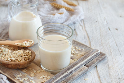 High angle view of oat flake with milk on wooden table