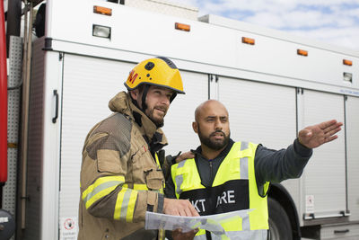 Security guard and firefighters discussing plan