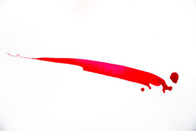 High angle view of red umbrella against white background