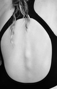 Rear view of young woman standing against white background