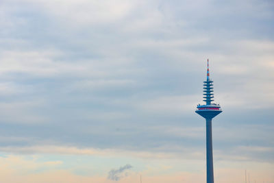 Low angle view of communications tower against sky