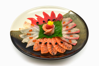 High angle view of flower in plate against white background