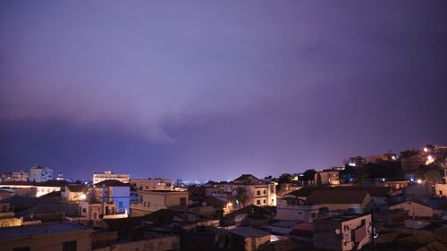 High angle view of illuminated buildings against sky at dusk
