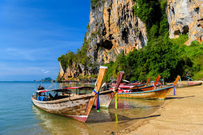 Boats moored on sea against sky