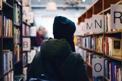 Rear view of woman in library