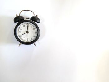 Directly above shot of alarm clock on gray background