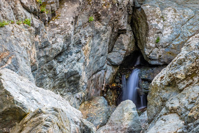 Low angle view of waterfall in rock formation