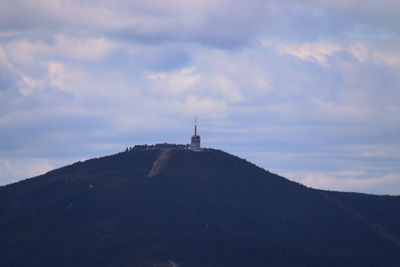 Lighthouse on mountain against sky