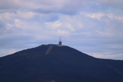 Lighthouse on mountain against sky