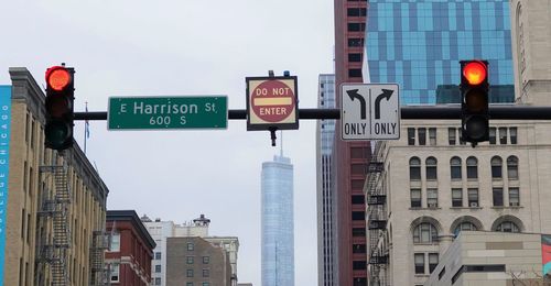 Low angle view of road sign against buildings