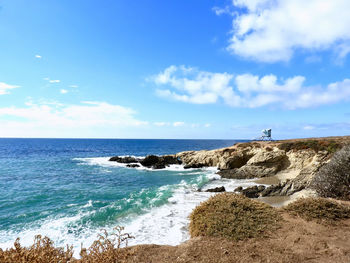 Scenic view of sea against blue sky