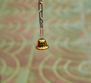 Close-up of electric lamp hanging on metal