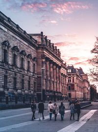 People walking on street against buildings in city