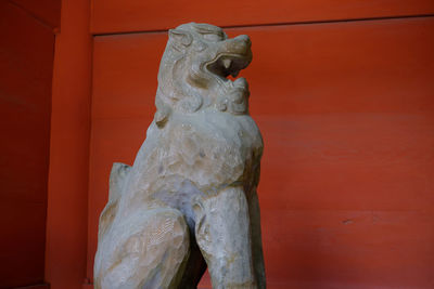 Low angle view of statue against wall