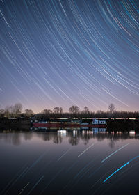 Scenic view of lake against sky at night