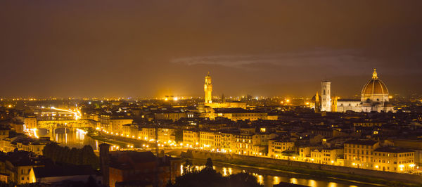 High angle view of city lit up at night