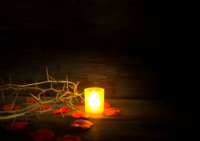 Close-up of illuminated lamp on table