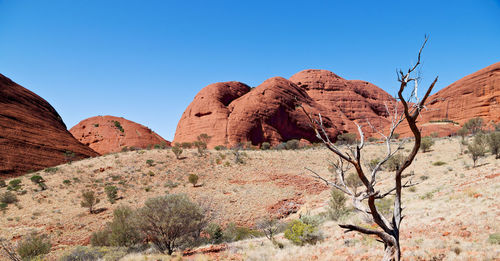 Rock formations in desert against clear blue sky