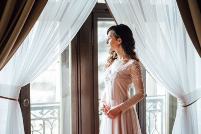 Woman standing in front of window