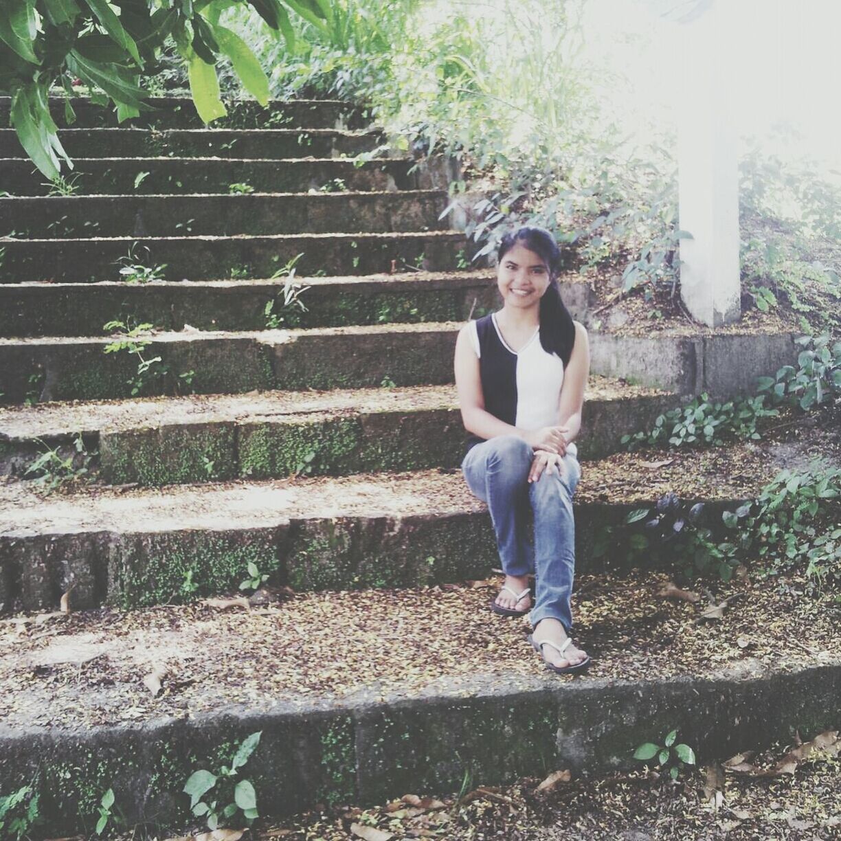 person, casual clothing, lifestyles, full length, steps, leisure activity, young adult, standing, tree, steps and staircases, looking at camera, portrait, plant, railing, staircase, built structure, young women, front view