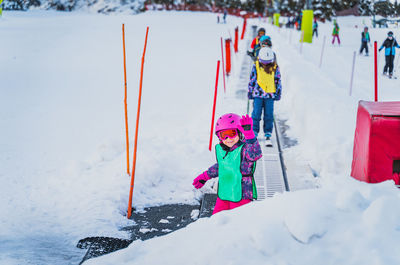 Young skier, girl going up on ski conveyor. ski winter holidays in andorra