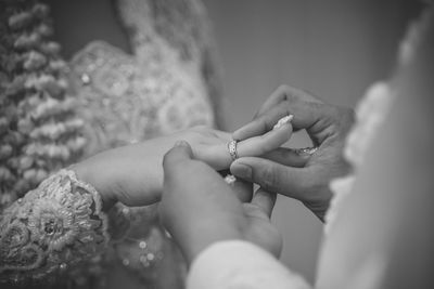 Midsection of couple holding hands