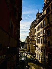 Canal amidst buildings in city against sky