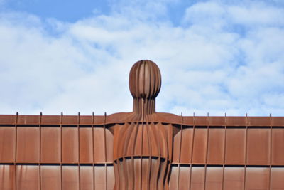 Low angle view of angel of the north against cloudy sky