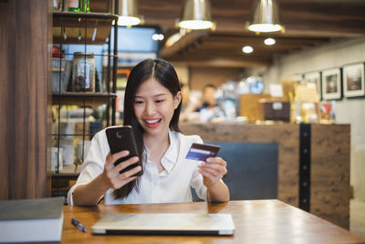 Portrait of young woman using mobile phone