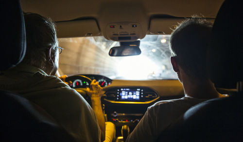 Italy, sicily, two men in car in a tunnel