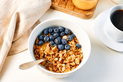 Granola with nuts and a cup of coffee for breakfast. balanced diet for vegetarians or vegans