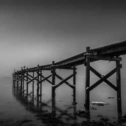 Pier over sea against clear sky