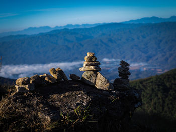 Stack of rocks against mountain range