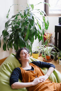 Portrait of smiling woman sitting at home