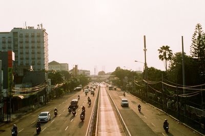 Traffic on road in city against sky