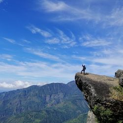 Full length of man standing on cliff against sky