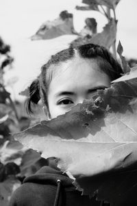 Close-up portrait of girl with leaves