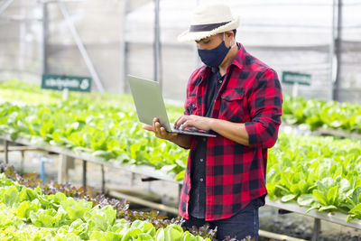 Midsection of man working with mobile phone